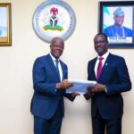 Mr Edun handing over the baton of office to Mr Oyedele 