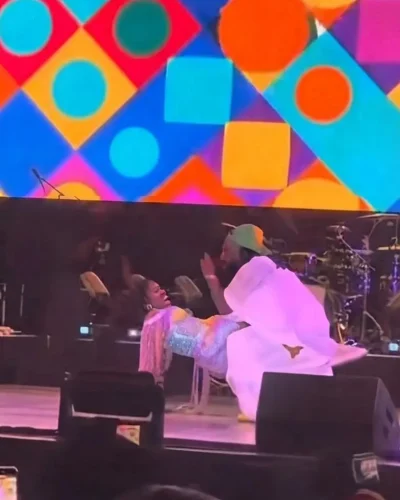 Real Warri Pikin being lifted by Timaya during his performance at the AFRIMMA Festival in Dallas, Texas.